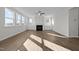 Inviting living room with wood floors, a cozy fireplace, and built-in cabinets under large windows at 432 Golden Dragonfly St, Wake Forest, NC 27587