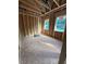 A view of the unfinished room with wooden frames and the placement of windows overlooking the landscape at 432 Golden Dragonfly St, Wake Forest, NC 27587