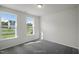 Well-lit room with neutral carpet, two large windows, and clean, white walls at 455 Beacon Hill Rd # 28, Lillington, NC 27546