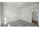 Well-lit bedroom with carpeted floors, neutral walls, and a bathroom view at 455 Beacon Hill Rd # 28, Lillington, NC 27546