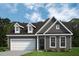 Charming home with neutral siding, white trim, two-car garage, and attractive landscaping at 455 Beacon Hill Rd # 28, Lillington, NC 27546