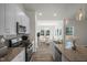 An open kitchen showcasing stainless steel appliances, granite counters, and an island with a sink at 455 Beacon Hill Rd # 28, Lillington, NC 27546