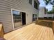 Wooden deck and siding leading to an open sliding glass door at 4903 Bridgewood Dr, Durham, NC 27713