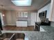 Bright kitchen featuring granite countertops, stainless steel appliances, white cabinets, and wood-look flooring at 4903 Bridgewood Dr, Durham, NC 27713