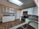 Well-lit kitchen featuring white cabinets, granite countertops, and modern appliances at 4903 Bridgewood Dr, Durham, NC 27713
