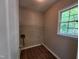 Practical laundry room with a large window and laminate flooring at 4903 Bridgewood Dr, Durham, NC 27713