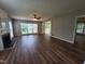 Spacious living room featuring wood-look floors, a ceiling fan, a fireplace, and plenty of natural light at 4903 Bridgewood Dr, Durham, NC 27713