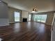 Inviting living room with a fireplace, wood-look flooring, and large windows that let in natural light at 4903 Bridgewood Dr, Durham, NC 27713