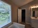This bright bathroom offers a double vanity and a bathtub next to a window at 4903 Bridgewood Dr, Durham, NC 27713