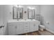 Modern bathroom featuring double sinks, white cabinets, grey walls, wood flooring, and a toilet at 50 Harriet Gentry Ln, Timberlake, NC 27583
