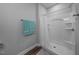 Bright bathroom showcasing a tiled shower with a white curtain, grey walls, and modern fixtures at 50 Harriet Gentry Ln, Timberlake, NC 27583