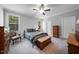 A cozy bedroom with neutral walls, plush carpet, and a comfortable bed and decorative wooden furniture at 50 Harriet Gentry Ln, Timberlake, NC 27583