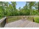 Inviting wooden deck with a view of the surrounding lush greenery, perfect for relaxation at 50 Harriet Gentry Ln, Timberlake, NC 27583