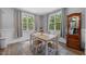 The light and airy dining room features neutral paint, two large windows, and a wood table with four chairs at 50 Harriet Gentry Ln, Timberlake, NC 27583