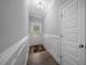 Bright foyer features wainscoting, hardwood floors, a decorative rug, and a front door with sidelights at 50 Harriet Gentry Ln, Timberlake, NC 27583
