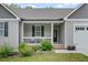 Charming front porch with black seating and landscaping, number 50 over the door, and a garage at 50 Harriet Gentry Ln, Timberlake, NC 27583