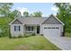 Charming single-Gathering home featuring a well-manicured lawn, attached garage, and inviting front porch at 50 Harriet Gentry Ln, Timberlake, NC 27583