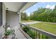 View from front porch overlooking driveway surrounded by landscaping and mature trees at 50 Harriet Gentry Ln, Timberlake, NC 27583