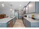 This open kitchen features gray cabinets, stainless steel appliances, granite counters, and a modern design at 50 Harriet Gentry Ln, Timberlake, NC 27583