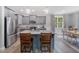 Bright eat-in kitchen features gray cabinets, granite countertops, stainless appliances and a view to the backyard at 50 Harriet Gentry Ln, Timberlake, NC 27583