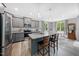 Modern kitchen with stainless steel appliances, granite countertops, an island with seating, and hardwood floors at 50 Harriet Gentry Ln, Timberlake, NC 27583