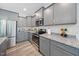This well-designed kitchen features stainless steel appliances, gray cabinets, and granite countertops at 50 Harriet Gentry Ln, Timberlake, NC 27583