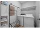 Well-equipped laundry room with a washer, dryer, shelving, and space for storage at 50 Harriet Gentry Ln, Timberlake, NC 27583
