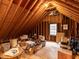 Unfinished attic space with exposed beams and a window, great for storage at 5009 Beckwyck Dr, Fuquay Varina, NC 27526