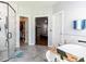 Bright bathroom with a glass shower, freestanding tub, and walk-in closet for a spa-like experience at 5009 Beckwyck Dr, Fuquay Varina, NC 27526