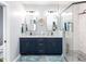 Modern bathroom featuring double sinks, framed mirrors, a walk-in shower and stylish fixtures at 5009 Beckwyck Dr, Fuquay Varina, NC 27526