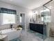 Luxurious bathroom with a freestanding tub, a glass enclosed shower, and double vanity sinks at 5009 Beckwyck Dr, Fuquay Varina, NC 27526