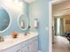 Bright bathroom with double sinks, granite countertops, and ensuite access to the bedroom at 5009 Beckwyck Dr, Fuquay Varina, NC 27526