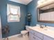 Charming bathroom with blue walls, vanity, and a window providing natural light at 5009 Beckwyck Dr, Fuquay Varina, NC 27526