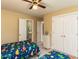 ' bedroom with dinosaur-themed decor, ceiling fan, and ensuite bathroom at 5009 Beckwyck Dr, Fuquay Varina, NC 27526