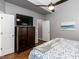 Comfortable bedroom with hardwood floors and a modern aesthetic featuring a large media center at 5009 Beckwyck Dr, Fuquay Varina, NC 27526