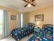 Cozy bedroom features dinosaur themed comforters, ceiling fan, and light-blocking curtains at 5009 Beckwyck Dr, Fuquay Varina, NC 27526