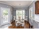Bright breakfast nook featuring a round wooden table and a window with patterned curtains at 5009 Beckwyck Dr, Fuquay Varina, NC 27526