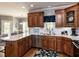 Spacious kitchen with custom wood cabinets, stainless steel appliances, and white countertops at 5009 Beckwyck Dr, Fuquay Varina, NC 27526