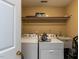 Practical laundry room featuring a sink and a washer and dryer, with shelving for storage at 5009 Beckwyck Dr, Fuquay Varina, NC 27526