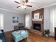 Cozy living room with a brick fireplace and a comfortable ottoman, perfect for relaxing at 5009 Beckwyck Dr, Fuquay Varina, NC 27526