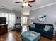 Comfortable living room with a dark blue couch, gray walls, and a view into the breakfast nook at 5009 Beckwyck Dr, Fuquay Varina, NC 27526