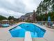 Backyard view of the in-ground pool, diving board and brick home with an inviting outdoor space for relaxation and entertainment at 5009 Beckwyck Dr, Fuquay Varina, NC 27526