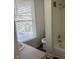 Well-lit bathroom featuring a tub, vanity, and window for natural light at 509 W Rose St, Sanford, NC 27330
