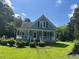 Inviting exterior view of a two-story home, surrounded by a lush green lawn at 509 W Rose St, Sanford, NC 27330