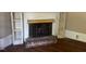 Fireplace with rustic brick and white shelving providing a warm focal point at 509 W Rose St, Sanford, NC 27330