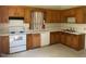 Functional kitchen with wood cabinets, white appliances, and plenty of counter space at 509 W Rose St, Sanford, NC 27330