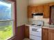 Functional kitchen with classic cabinetry, a white oven, and natural lighting at 509 W Rose St, Sanford, NC 27330
