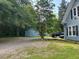Gravel parking area in the backyard with a shed near a blue, two-story home at 509 W Rose St, Sanford, NC 27330
