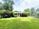 Expansive green backyard showcasing a well-maintained lawn, perfect for outdoor activities and relaxation at 518 Heater Dr, Cary, NC 27511
