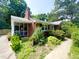 Charming brick home featuring a screened-in porch, mature landscaping, and a welcoming walkway at 518 Heater Dr, Cary, NC 27511